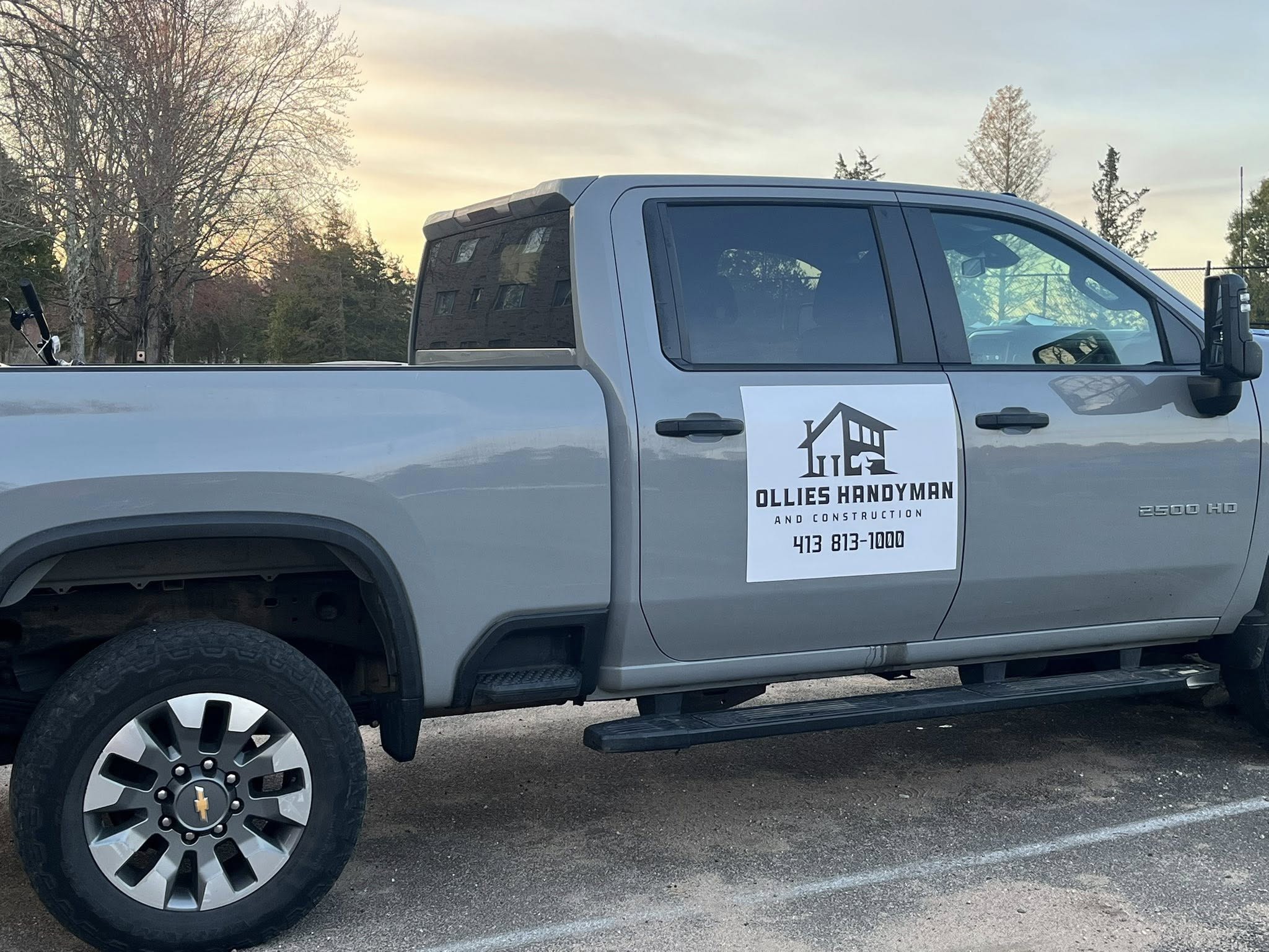 Ollie's Sons LLC service truck with contact information